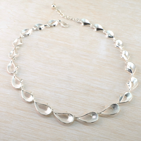 Graduated Satin and Polished Silver Linked Necklace by JB Designs.