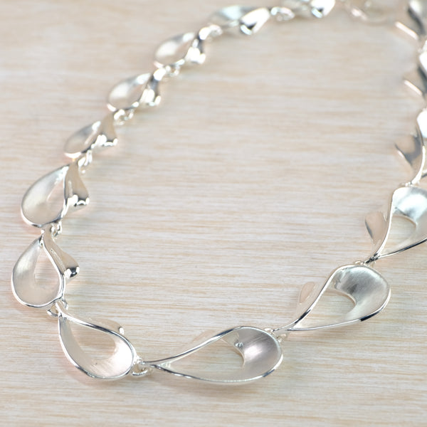 Graduated Satin and Polished Silver Linked Necklace by JB Designs.