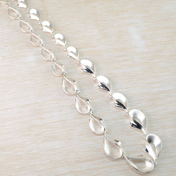 Graduated Satin and Polished Silver Linked Necklace by JB Designs.
