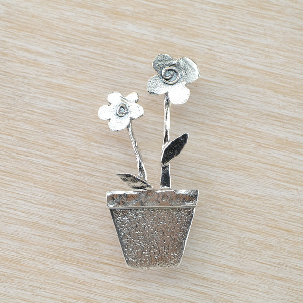 silver brooch with two flowers in a pot