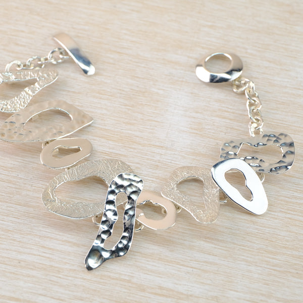 Multi Textured Sterling Silver Linked Bracelet.