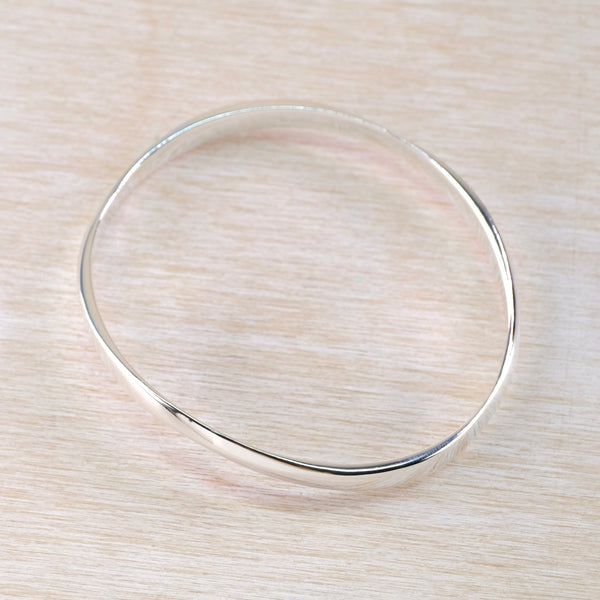 Gently Curved Sterling Silver Bangle.