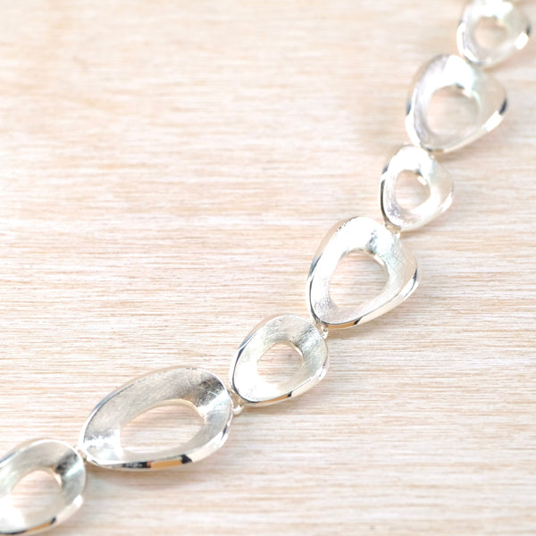 Organic Satin and Polished Silver Link Bracelet.