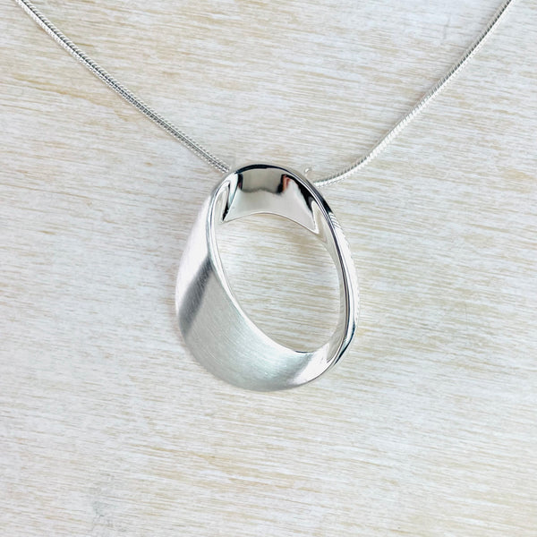 Brushed and Polished Silver Mobius Pendant by JB Designs. Brushed and Polished Silver Mobius Pendant by JB Designs.