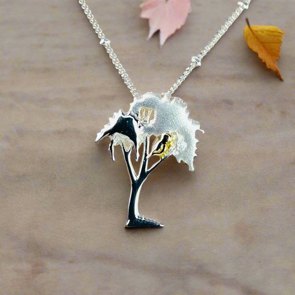 Sterling Silver Tree Pendant with Gold Detail.