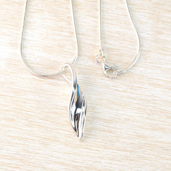 Polished Silver Pendant with Twisty Leaf Design.