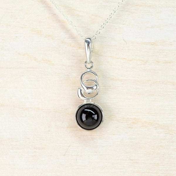 Silver pendant with a black gemstone and a silver twist settng. Silver pendant with a black gemstone and a silver twist settng.