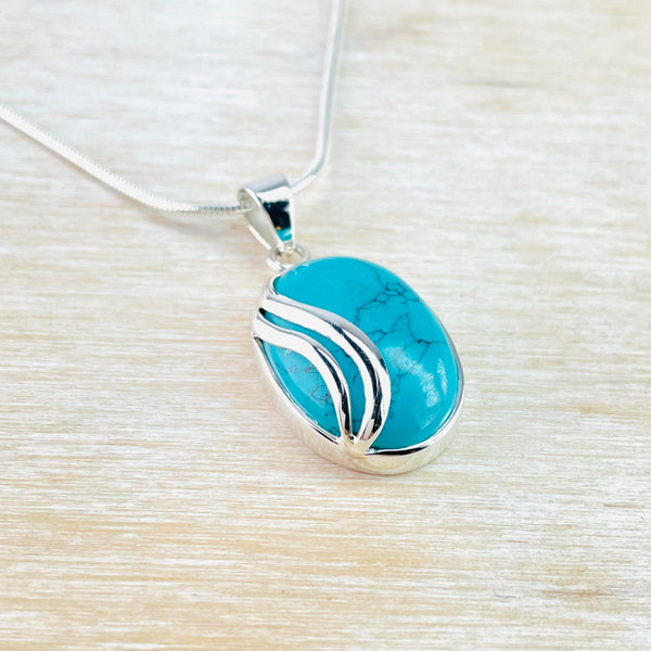 Oval Turquoise Pendant with Sterling Silver Overlay.