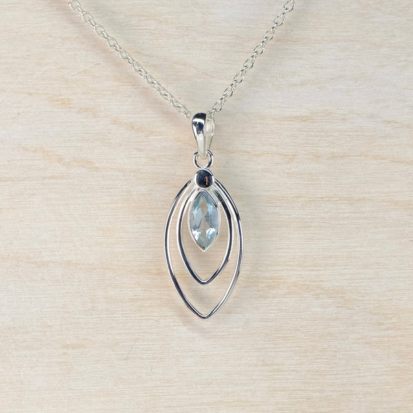 Silver pendant necklace with a translucent blue gemstone on a silver chain