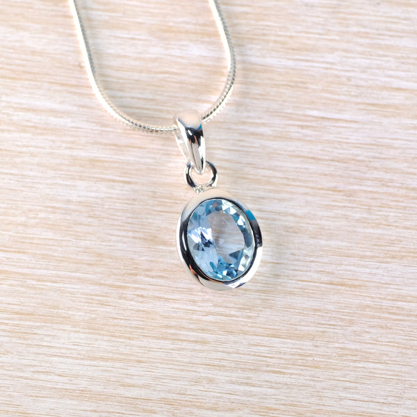 Simple Oval Blue Topaz and Silver Pendant.