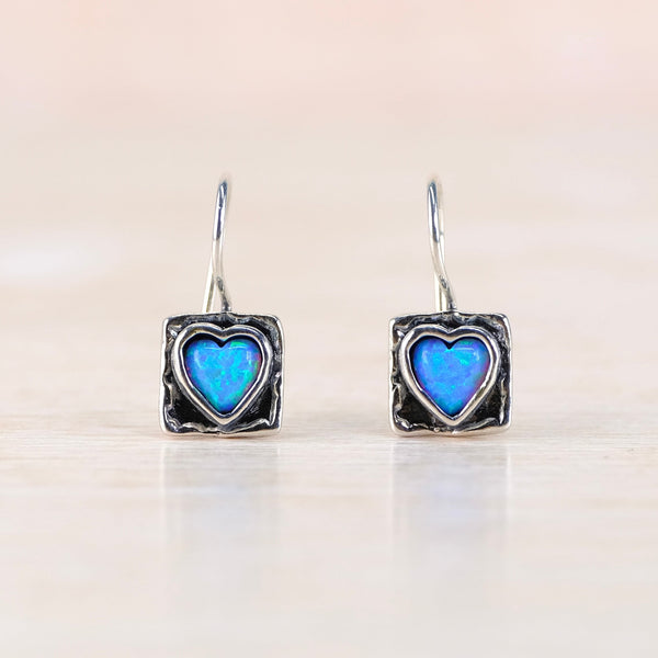 silver square drop earrings with a heart shaped blue stone