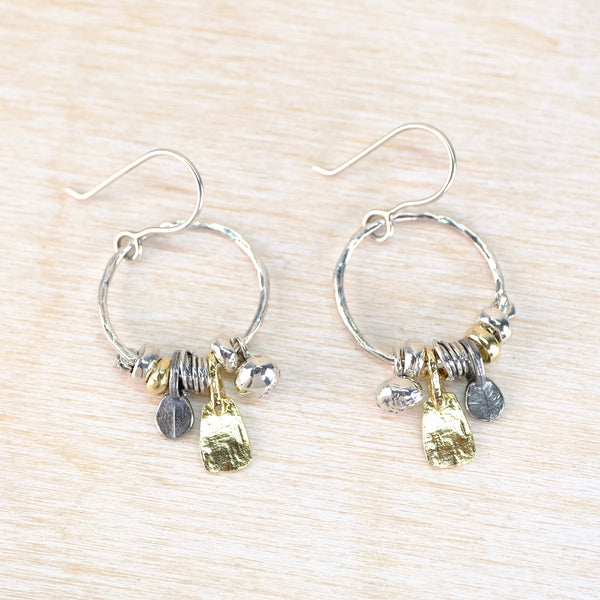 silver earings with multi elements dangling from a hoop.