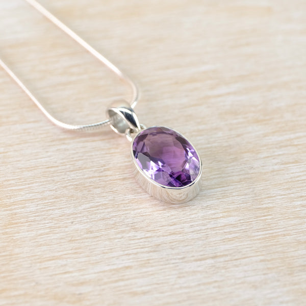 Oval Sterling Silver and Faceted Amethyst Pendant.