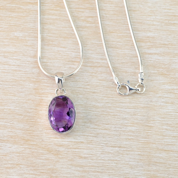 Oval Sterling Silver and Faceted Amethyst Pendant.
