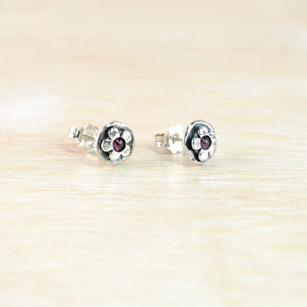 Garnet and Silver Flower Stud Earrings.