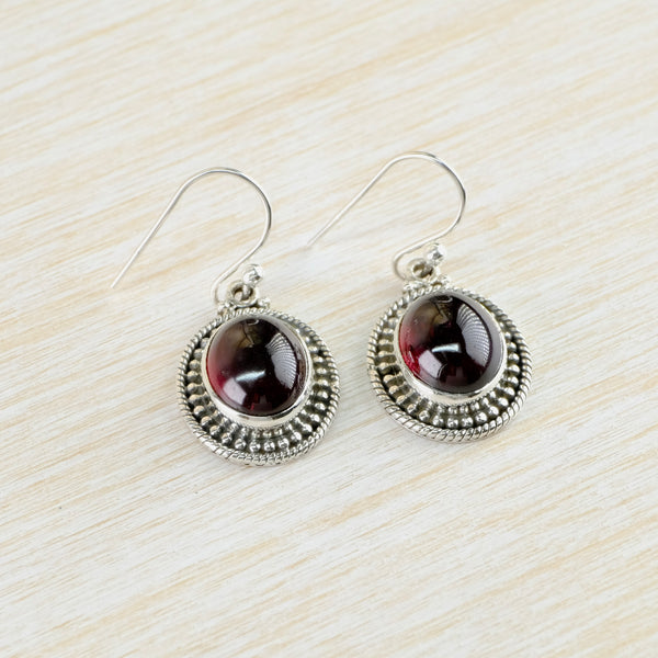 Decorated Oval Sterling Silver and Cabochon Garnet Drop Earrings.