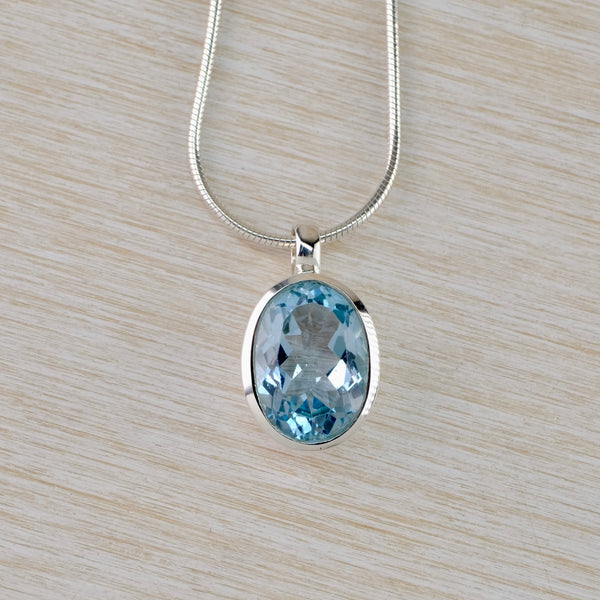 Simple Oval Blue Topaz and Silver Pendant.