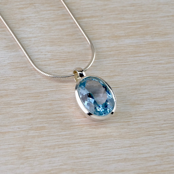Simple Oval Blue Topaz and Silver Pendant.