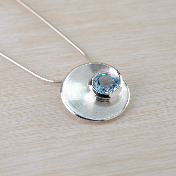 Blue Topaz and Satin Silver Pendant by JB Designs.