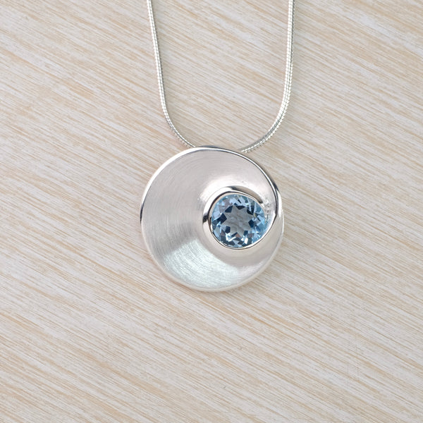 Blue Topaz and Satin Silver Pendant by JB Designs.