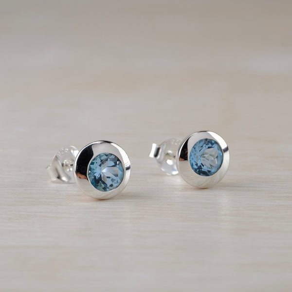 Round Silver and Blue Topaz Hemisphere Stud Earrings.