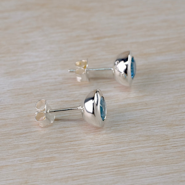 Round Silver and Blue Topaz Hemisphere Stud Earrings.