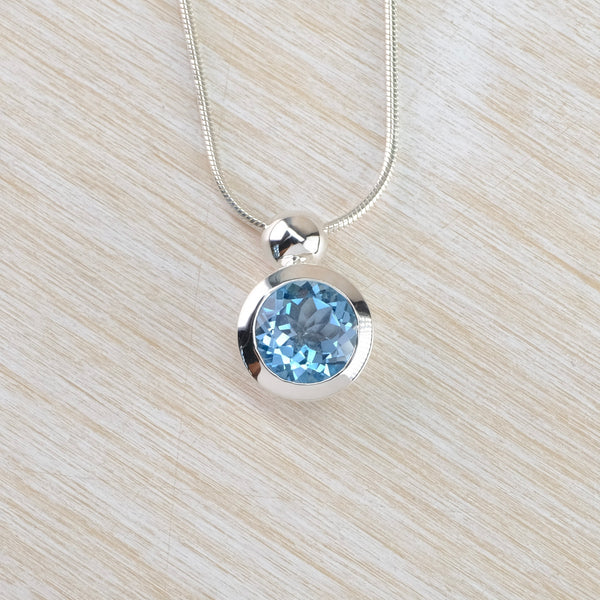 Round Blue Topaz and Sterling Silver Pendant.