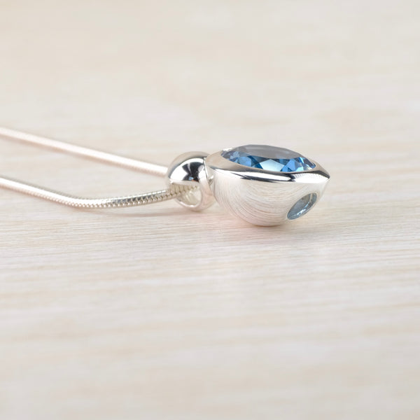Round Blue Topaz and Sterling Silver Pendant.