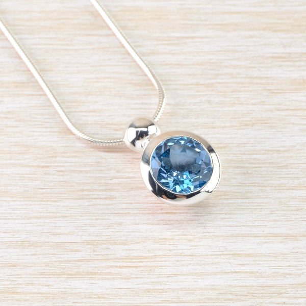 Round Blue Topaz and Sterling Silver Pendant.
