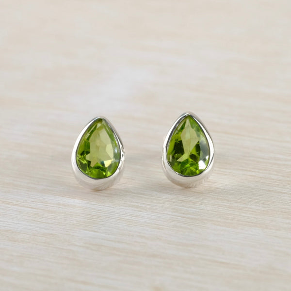 Teardrop shaped green gemstone stud earrings set in silver