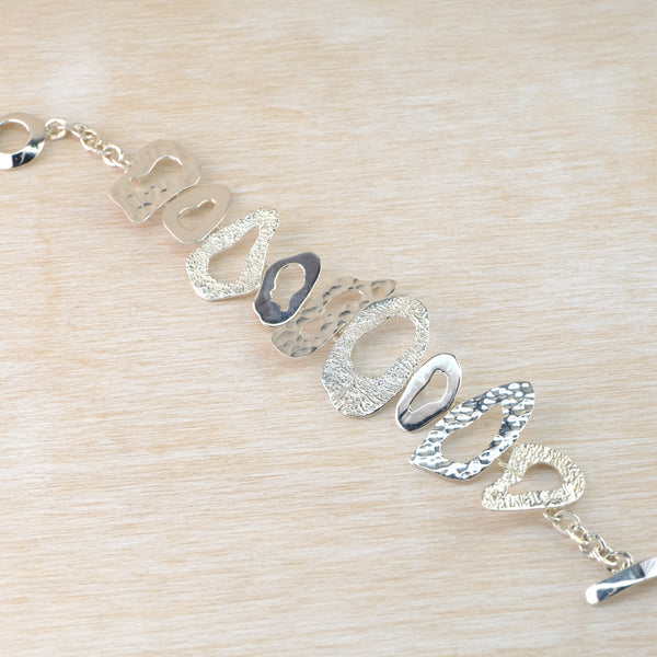Multi Textured Sterling Silver Linked Bracelet.