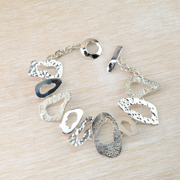 Multi Textured Sterling Silver Linked Bracelet.