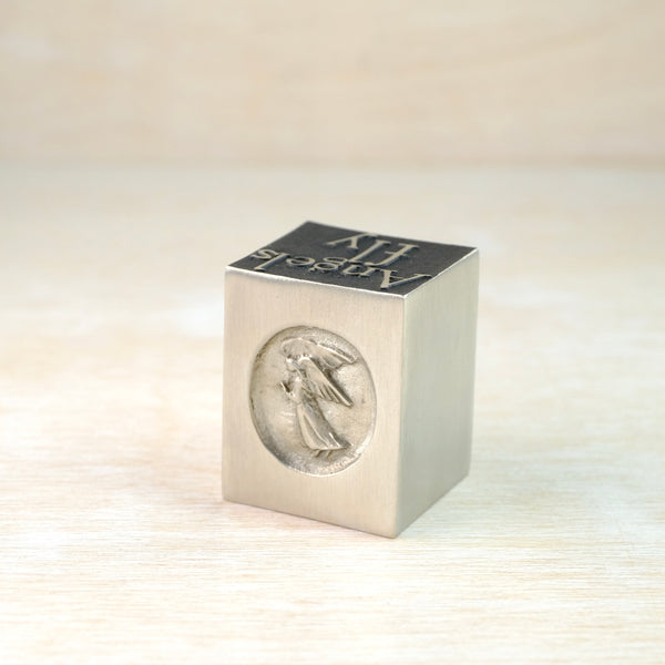A Solid Pewter 'Angels Fly' Cube