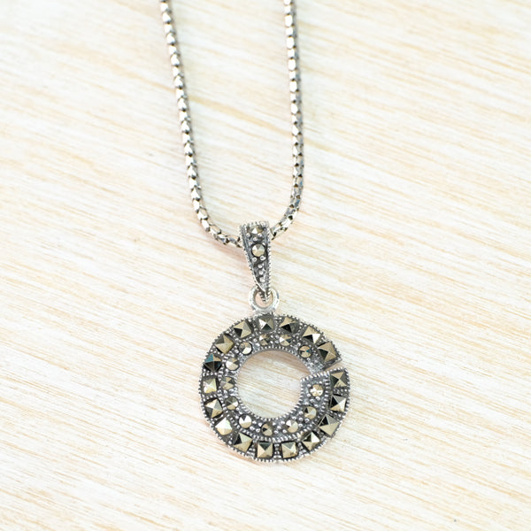 Silver necklace with a circular pendant 