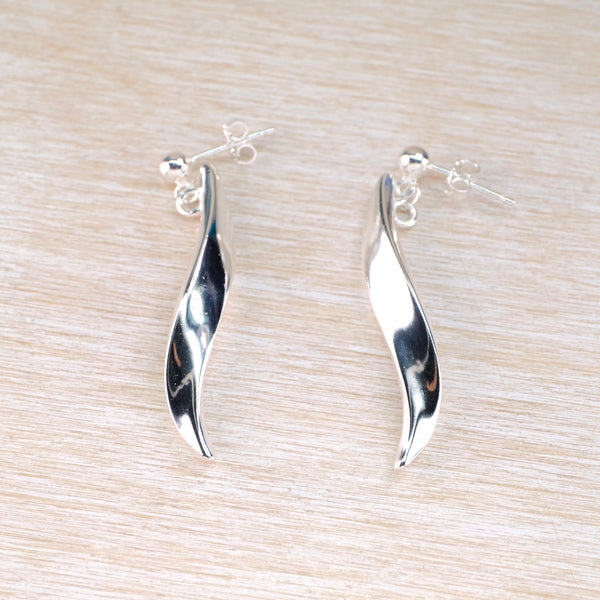 shiny silver earrings with a dangly twist shape