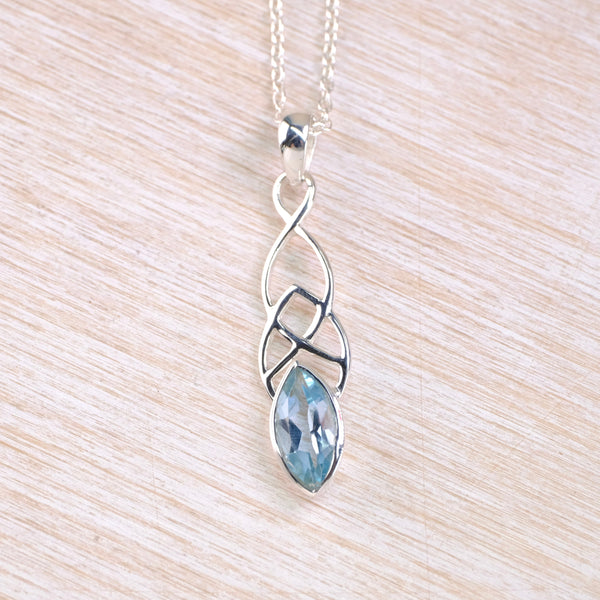Silver necklace with a blue  topaz pendant  with celic knot design