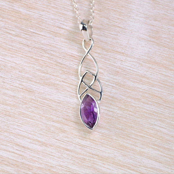 Silver pendant with a purple gemstone with a celtic knot design