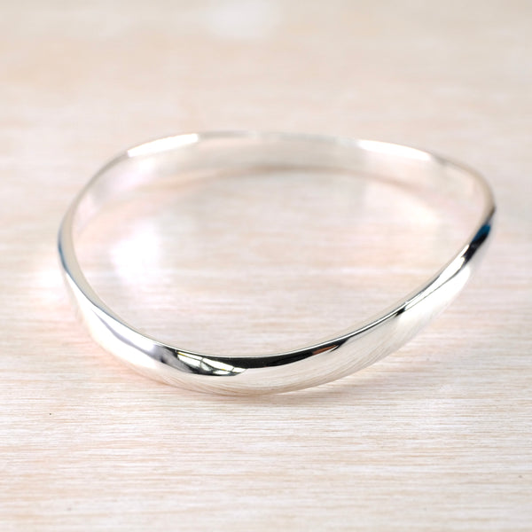 Gently Curved Sterling Silver Bangle.