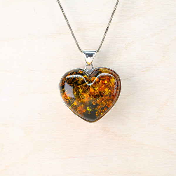 Heart-shaped amber pendant on a  long silver chain 