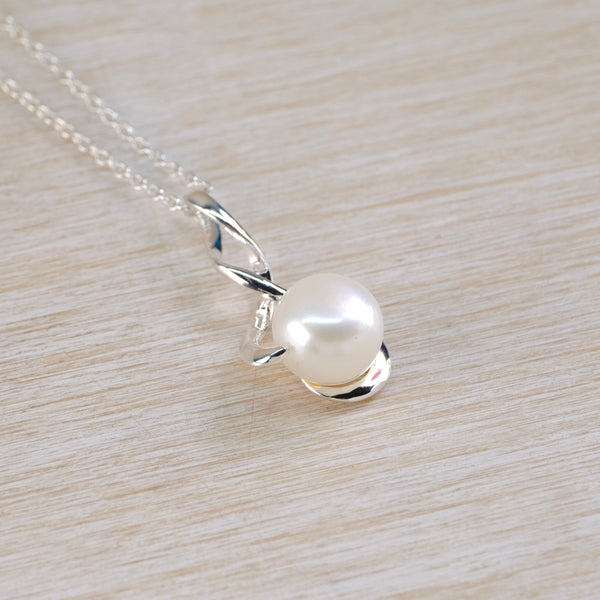 Pearl necklace set in a  silver twist  surround and with a silver chain 