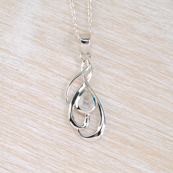 Silver necklace set with a pale moonstone in a swirl surround on a sliver chain