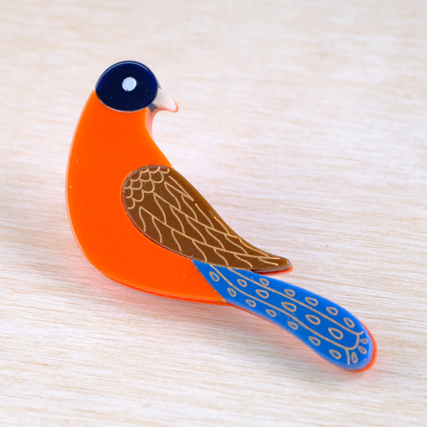 Colourful bird-shaped brooch  in orange and blue.