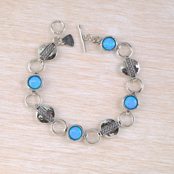 Silver bracelet with blue gemstones set in circular links
