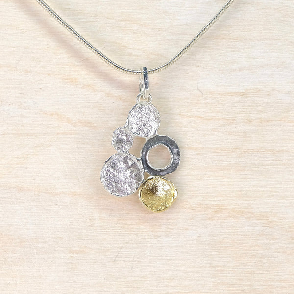 Necklace with a unique pendant on a light wooden background