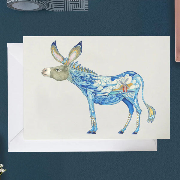 Greeting card with a blue donkey design on a dark blue wall.