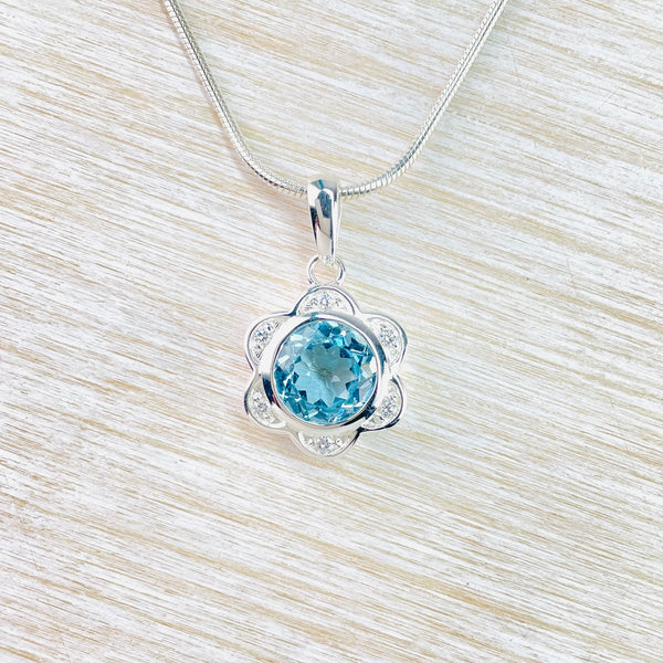 Blue Topaz and Silver Flower Pendant.