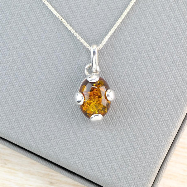 Oval Baltic Amber and Sterling Silver Pendant with Feature Overlay.