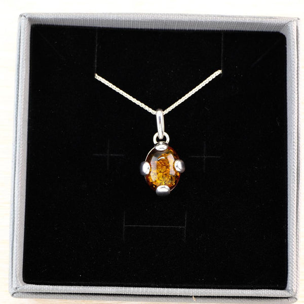 Oval Baltic Amber and Sterling Silver Pendant with Feature Overlay.