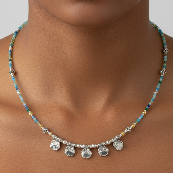 Necklace with small stones and silver pendants on a model