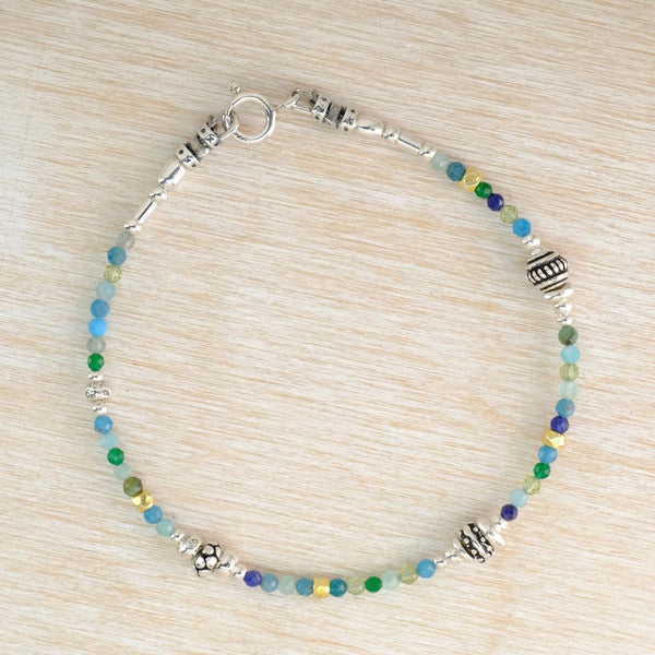 a beaded bracelet with blue and green emstones an silver beads